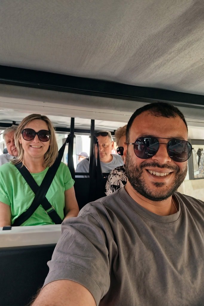 Happy tourists enjoying a ride in one of our covered vehicles.